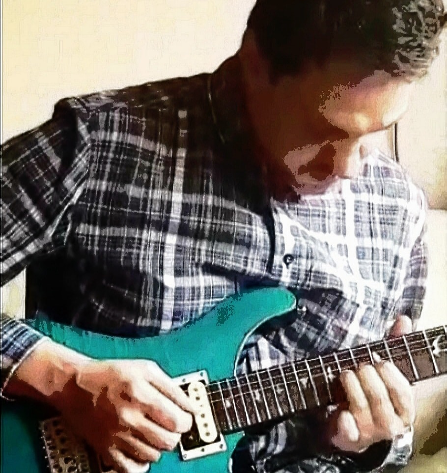 Martin playing guitar in the tuition studio